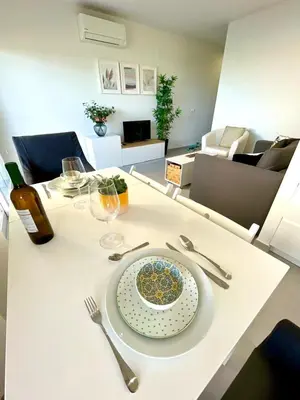 a white table with a plate of food on it at GATU PREMIUM Sandia Beach lujo junto al mar, parking y piscina común,