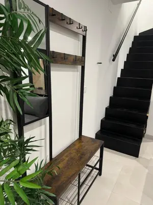 a wooden bench in a room with stairs at Villa Zeus in Rota