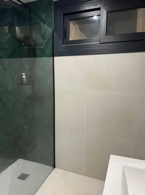 a shower with a glass door next to a toilet at Villa Zeus in Rota
