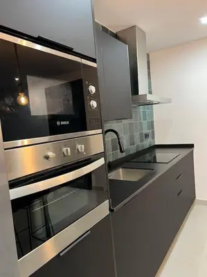 a kitchen with a stainless steel oven and a sink at Villa Zeus in Rota