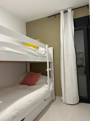 a bedroom with two bunk beds with a red pillow at Villa Zeus in Rota