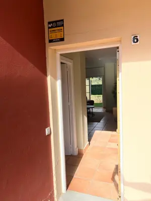 a hallway of a house with a sign on the wall at Casa piscina Playa Barrosa Delfin 6 in Chiclana de la Frontera