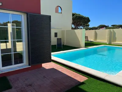 a swimming pool in front of a house at Casa piscina Playa Barrosa Delfin 6 in Chiclana de la Frontera