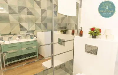 a bathroom with a sink and a toilet and a shower at Elcano Village by Sanlucar Housing in Sanlúcar de Barrameda