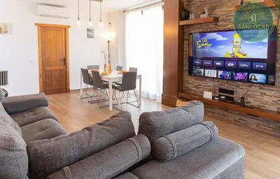 a living room with a couch and a tv at Elcano Village by Sanlucar Housing in Sanlúcar de Barrameda