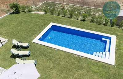 an overhead view of a swimming pool in a yard with chairs at Elcano Village by Sanlucar Housing in Sanlúcar de Barrameda
