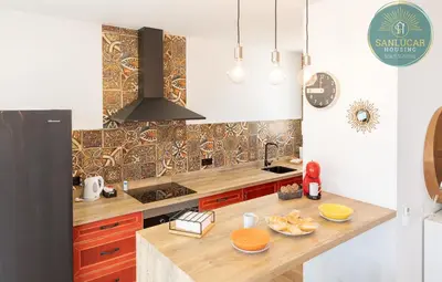 a kitchen with a wooden counter top and a sink at Elcano Village by Sanlucar Housing in Sanlúcar de Barrameda