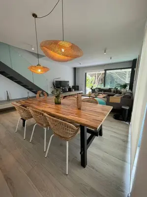a wooden table and chairs in a living room at Exclusivo chalet en urbanización Roche in Conil de la Frontera