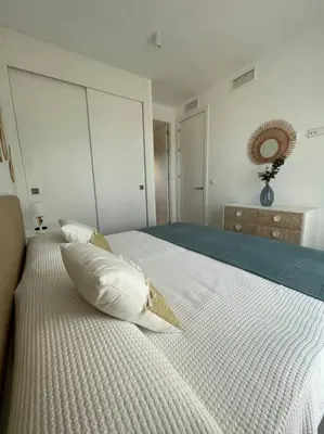 a white bed with a pillow on top of it at Exclusivo chalet en urbanización Roche in Conil de la Frontera