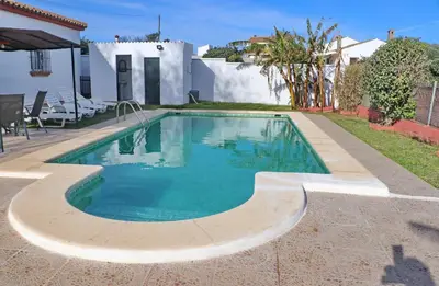 a swimming pool in the backyard of a house at Chalet Verde Agua in Conil de la Frontera