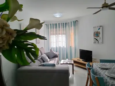 a living room with a couch and a table at Casita de la Infanta by Sanlúcar Housing in Sanlúcar de Barrameda