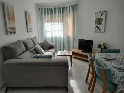 a living room with a couch and a table at Casita de la Infanta by Sanlúcar Housing in Sanlúcar de Barrameda