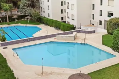 an overhead view of two large swimming pools at Apartamento en Puerto de Santa María, Playa Las Redes in El Puerto de Santa María