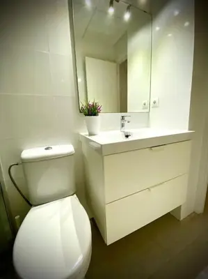 a bathroom with a toilet and a sink and a mirror at MyChoice Toledo in Rota