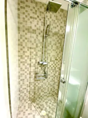 a shower with a glass door in a bathroom at MyChoice Toledo in Rota
