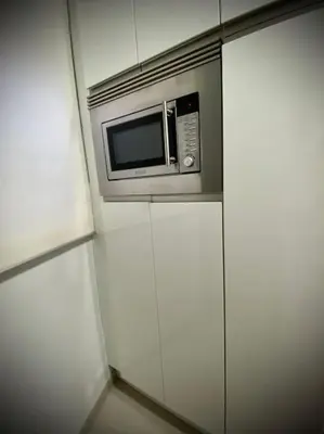 a microwave oven sitting on top of white cabinets at MyChoice Toledo in Rota