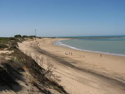 a group of people walking on a beach at MyChoice Toledo in Rota