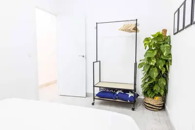 a bathroom with a mirror and a potted plant at La Casa del Mercader by Gades Gestión in Cádiz