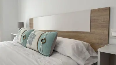 a white bed with pillows on top of it at Luz Baal Grupo AC Gestion in Cádiz