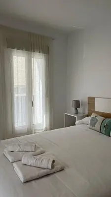 a white bed with two towels on top of it at Luz Baal Grupo AC Gestion in Cádiz