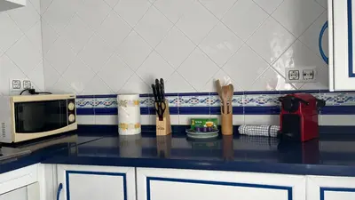 a kitchen with a counter top with a microwave at Luz Baal Grupo AC Gestion in Cádiz
