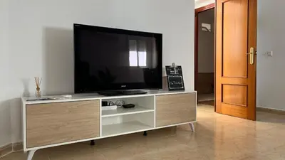 a flat screen tv sitting on top of a entertainment center at Luz Baal Grupo AC Gestion in Cádiz