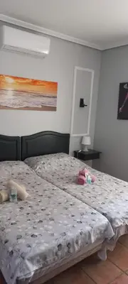 a bedroom with a bed with stuffed animals on it at APARTAMENTOS LUZ DE LA BAHÍA SUR CADIZ San Fernando in San Fernando