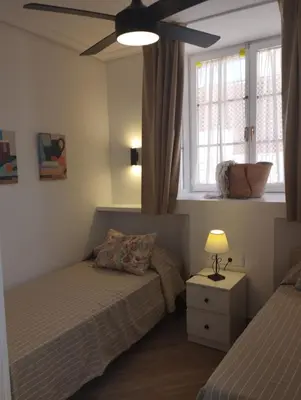 a bedroom with two beds and a window at APARTAMENTOS LUZ DE LA BAHÍA SUR CADIZ San Fernando in San Fernando