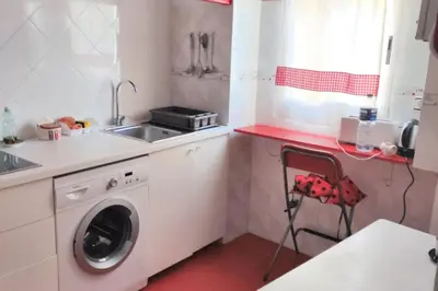 a kitchen with a washing machine and a sink at Charming apartment in Arcos de la Frontera, 70 m² with balcony in Arcos de la Frontera