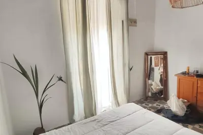 a bedroom with a bed and a mirror and a window at Charming apartment in Arcos de la Frontera, 70 m² with balcony in Arcos de la Frontera