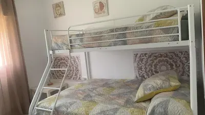 a bedroom with two bunk beds with a bed at Villa Irina in Chiclana de la Frontera