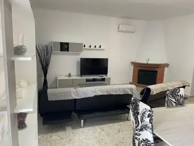 a living room with a couch and a tv at Villa Irina in Chiclana de la Frontera