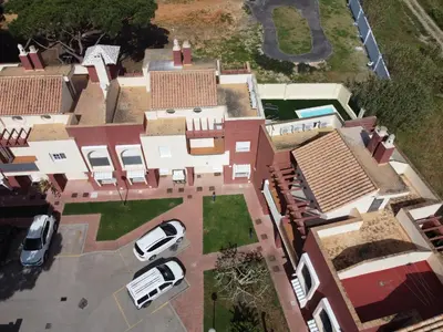 an aerial view of a house with cars parked in a driveway at Casa piscina playa Barrosa Delfin 7 in Chiclana de la Frontera