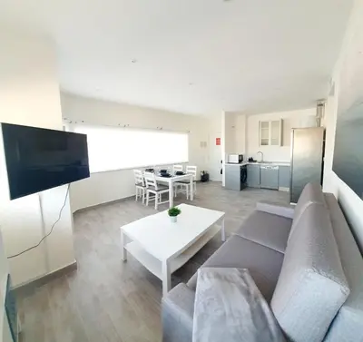 a living room with a couch and a table at Playa Doñana 1 in Sanlúcar de Barrameda