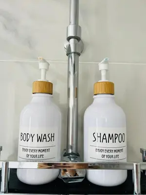 two bottles of laundry detergent sitting on a shelf at Villa Horacia - Playa de la Jara con Piscina in Sanlúcar de Barrameda