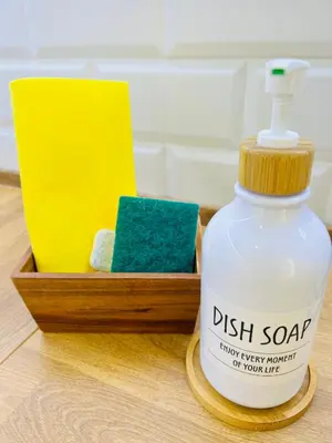 a bottle of dish soap next to a wooden box at Villa Horacia - Playa de la Jara con Piscina in Sanlúcar de Barrameda