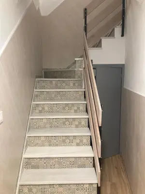 a set of stairs in a room with a door at La Casa de la Fuente in Sanlúcar de Barrameda