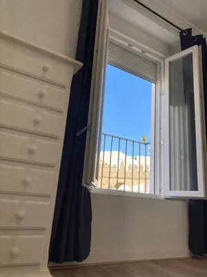 a bedroom with a window with a view of the beach at La Casa de la Fuente in Sanlúcar de Barrameda
