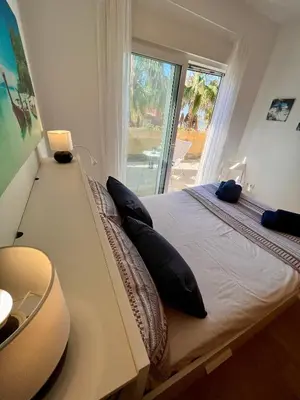 a bedroom with a large bed with a large window at GATU Villa Atardecer en la playa de las Redes 