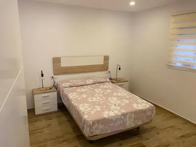 a bedroom with a bed and a dresser and a window at Apartamento La Saeta in Jerez de la Frontera