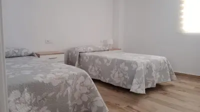 two beds sitting next to each other in a bedroom at Apartamento La Saeta in Jerez de la Frontera