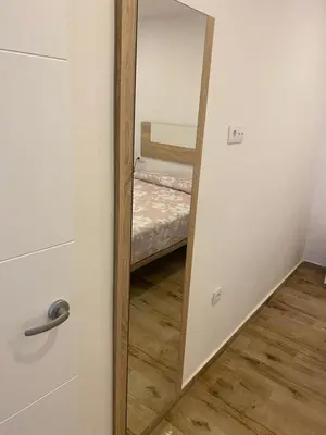 a mirror in a room with a bed in it at Apartamento La Saeta in Jerez de la Frontera