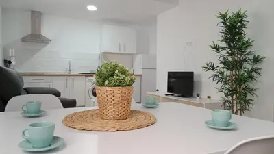 a white table with a vase on top of it at Apartamento La Saeta in Jerez de la Frontera