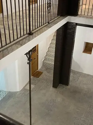 a set of stairs with a wooden door in a building at Apartamento AstaRegia in Jerez de la Frontera