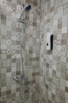a shower in a bathroom with a tile wall at Apartamento AstaRegia in Jerez de la Frontera