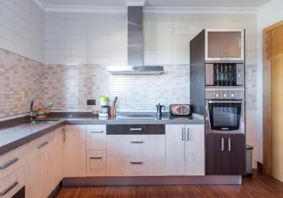 a kitchen with a sink and a stove at CASA VARAVILLA in Conil de la Frontera