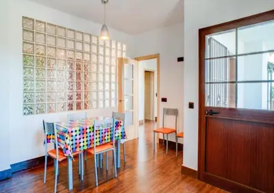 a dining room with a table and chairs and a door at CASA VARAVILLA in Conil de la Frontera