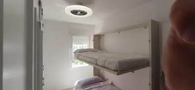 a small room with a bunk bed and a window at JT CHICLANA, ,Parking, Aire, Wifi, TV, Terraza in Chiclana de la Frontera