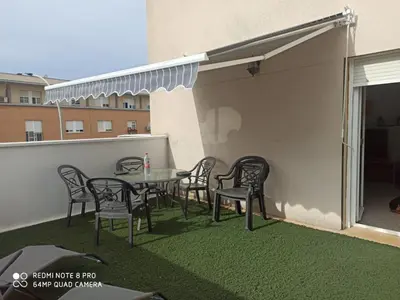 a patio with a table and chairs on a balcony at JT CHICLANA, ,Parking, Aire, Wifi, TV, Terraza in Chiclana de la Frontera
