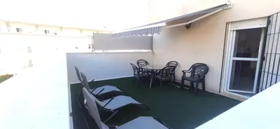 a patio with a table and chairs on a balcony at JT CHICLANA, ,Parking, Aire, Wifi, TV, Terraza in Chiclana de la Frontera